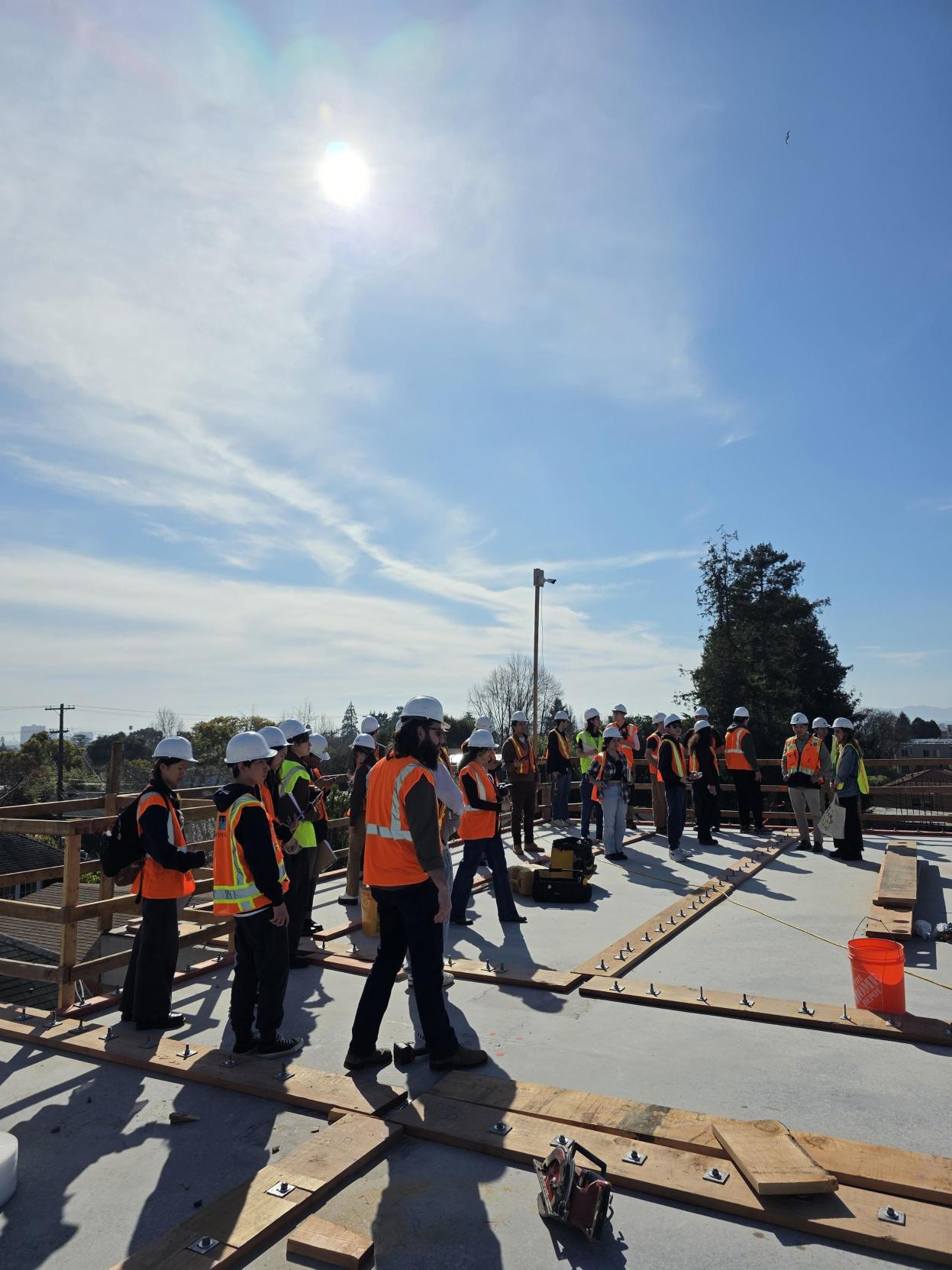 UC Berkeley students walking the rooftop at 1598 University Apartments during a Synergy Modular site visit